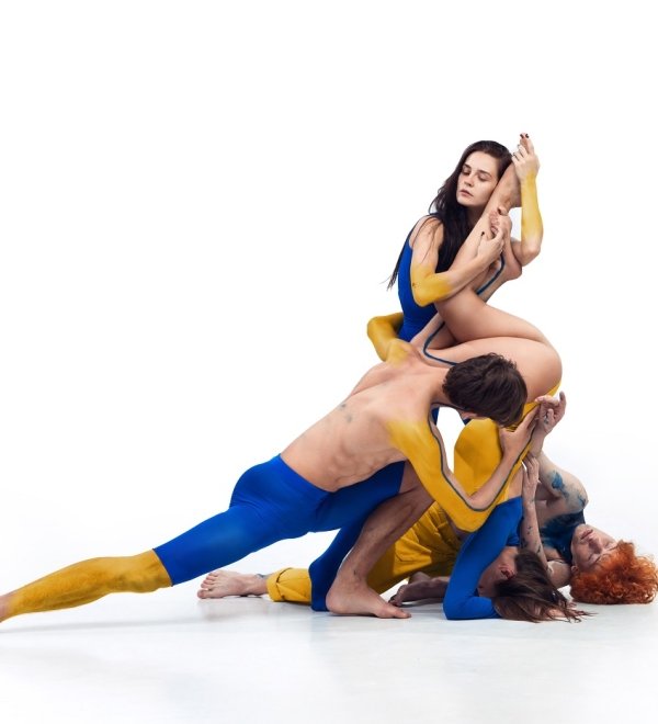  group of modern ballet dancers painted in blue and yellow colors of Ukrainian flag
