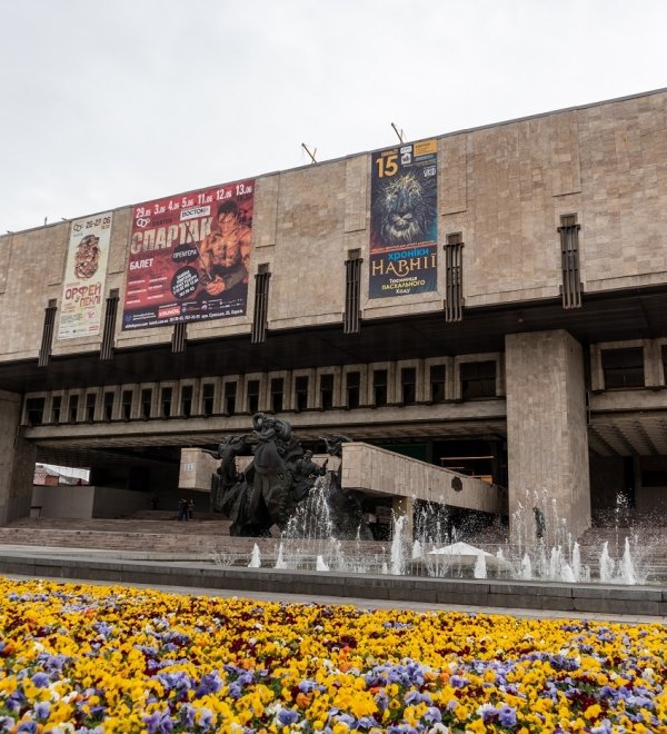 Kharkiv, Ukraine - May 08, 2021: The Kharkiv State Academic Opera and Ballet Theatre with fountains and vibrant pansies flowers blooming in spring