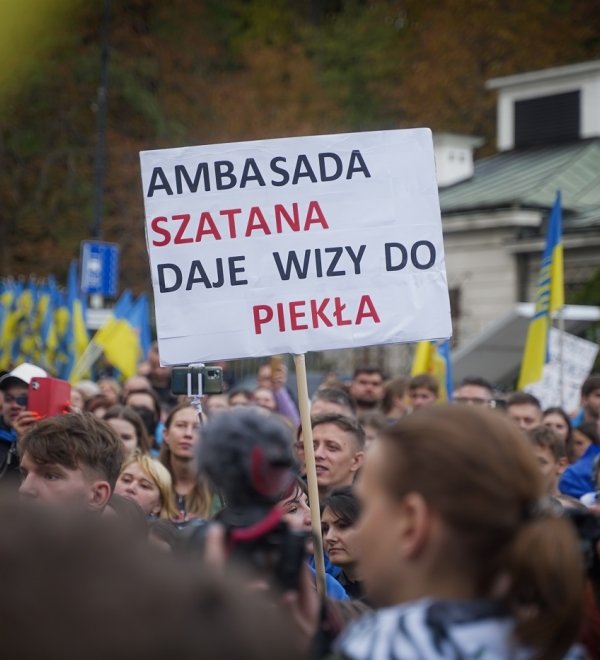 A man in Warsaw, Poland holds a sign protesting the Russian invasion of Ukraine