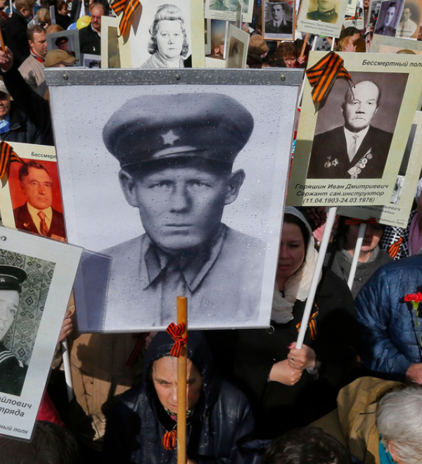 Residents of St. Petersburg, Russia, carry portraits of family members who served in World War Two on Victory Day in 2014 as part of an "Immortal Regiment" march. (Dmitry Lovetsky / ​AP / ​Shutterstock