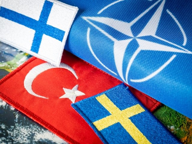 Turkish, Finnish, and Swedish flags next to a NATO flag