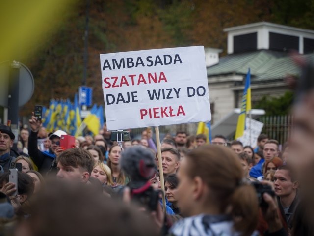 A man in Warsaw, Poland holds a sign protesting the Russian invasion of Ukraine