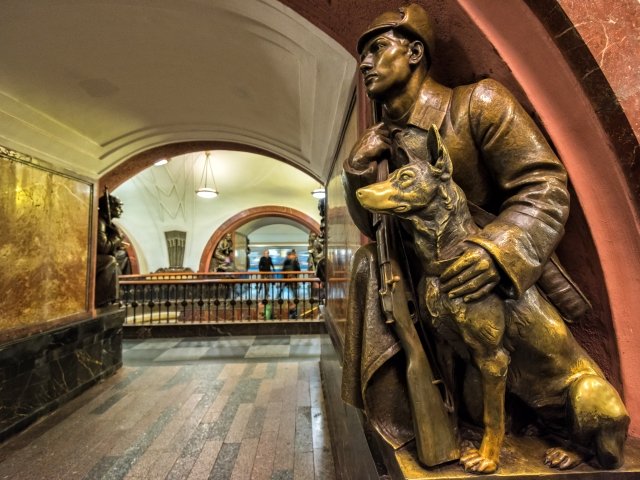 A Soviet border guard and his dog (1938) at the Revolution Square subway station in Moscow.