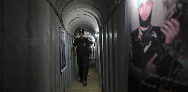 A Palestinian youth walks inside a tunnel used for military exercises during a weapon exhibition at a Hamas-run youth summer camp in Gaza City July 20, 2016. 