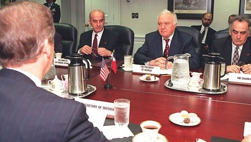 Secretary of Defense William S. Cohen (left, back to camera) meets with a delegation from Georgia led by President Eduard Shevardnadze (center), and including, among others, Minister of Foreign Affairs Irakli Menagarishvili (left, facing camera), and Mr. Charkviani, head of the Foreign Relations Department, serving here as interpreter (right).