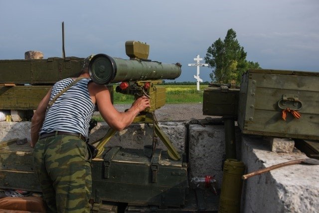 A separatist guards his position near the division line with Ukrainian army with anti-tank missile near Dokuchaevsk, eastern Ukraine, Friday, June 5, 2015