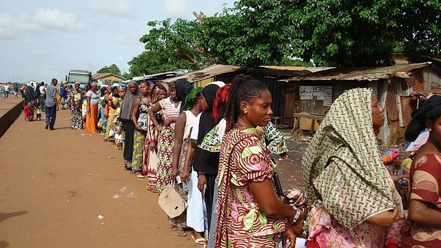 Voters line up to vote in Guinea's 2010 election. Photo by UN  Development Programme, Creative Commons.