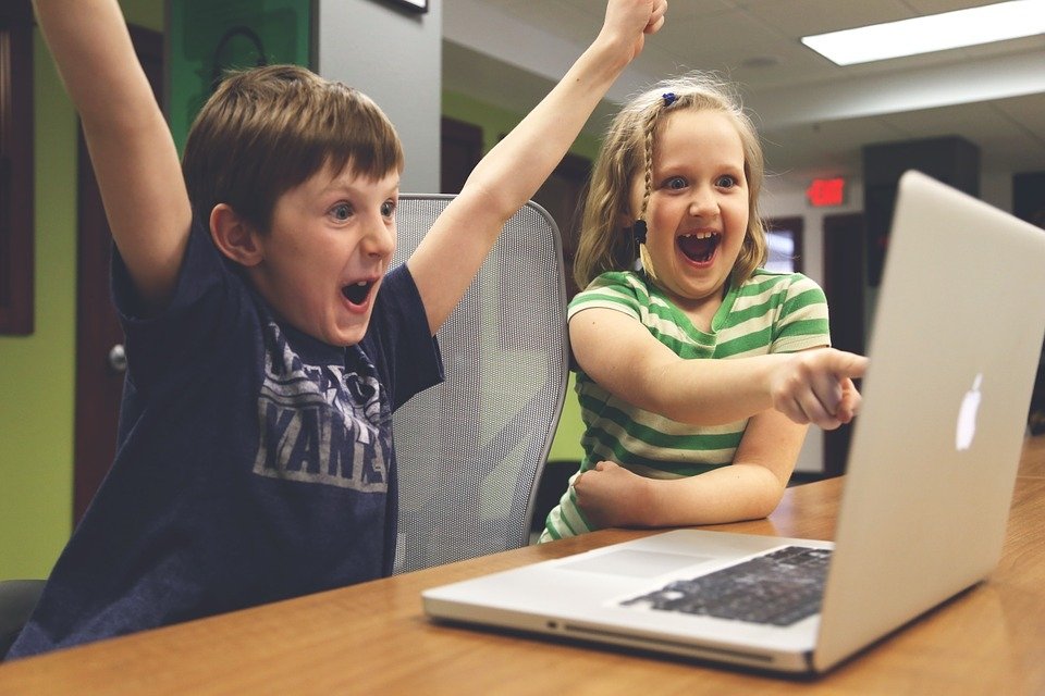 Children playing at a laptop computer