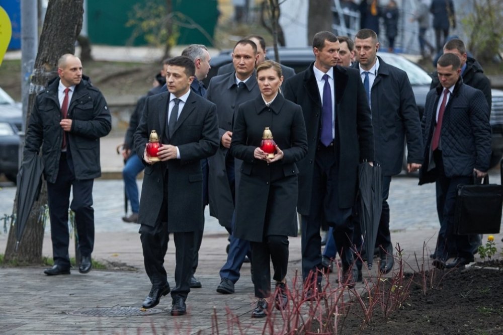 Ukrainian President Volodymyr Zelenskyy and his wife, Olena Zalenska, hold candles as they walk to a memorial in Independence Square in Kyiv, Ukraine. Source: President.gov.ua
