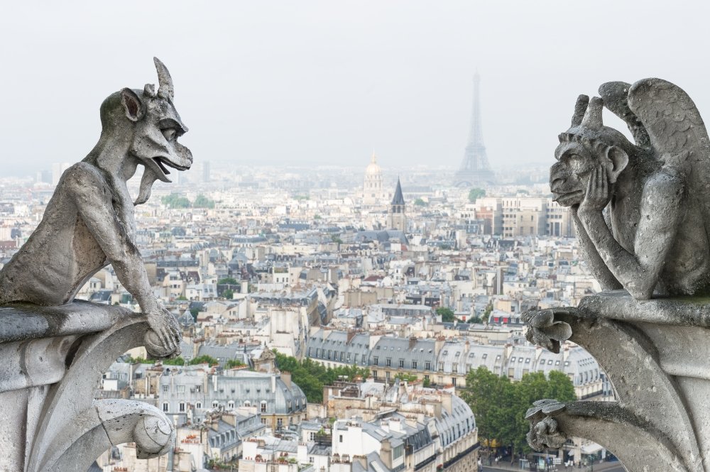 Stone gargoyle and chimera with Paris city on background. View from Notre Dame de Paris. Source: Shutterstock.