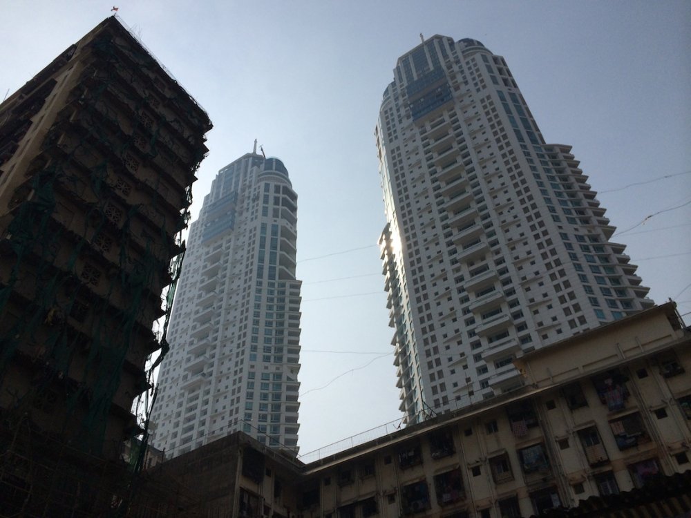 Imperial Towers, a twin-tower residential skyscraper complex in South Mumbai, are built on former slum land. Surrounding the luxury towers are rehabilitation buildings for former slum dwellers.