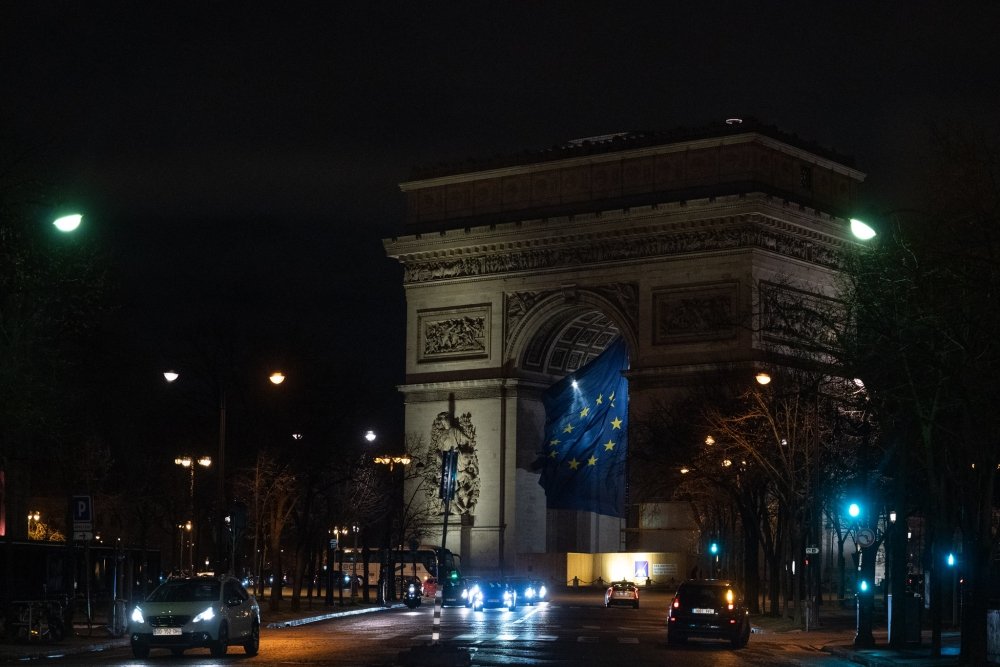 EU flag flying under the Arc de Triomphe