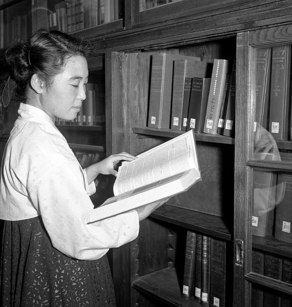 A student doing research in the library of Ewha Women's University in Seoul. 01 September 1954.