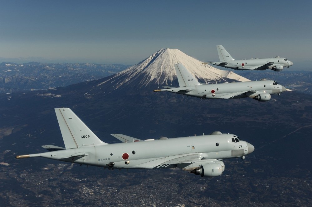 Three JMSDF planes in flight with Mount Fuji in the background.