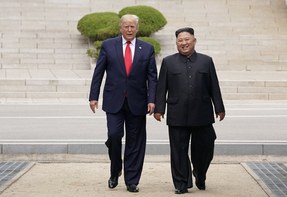 Donald Trump and Kim Jong Un walking together.