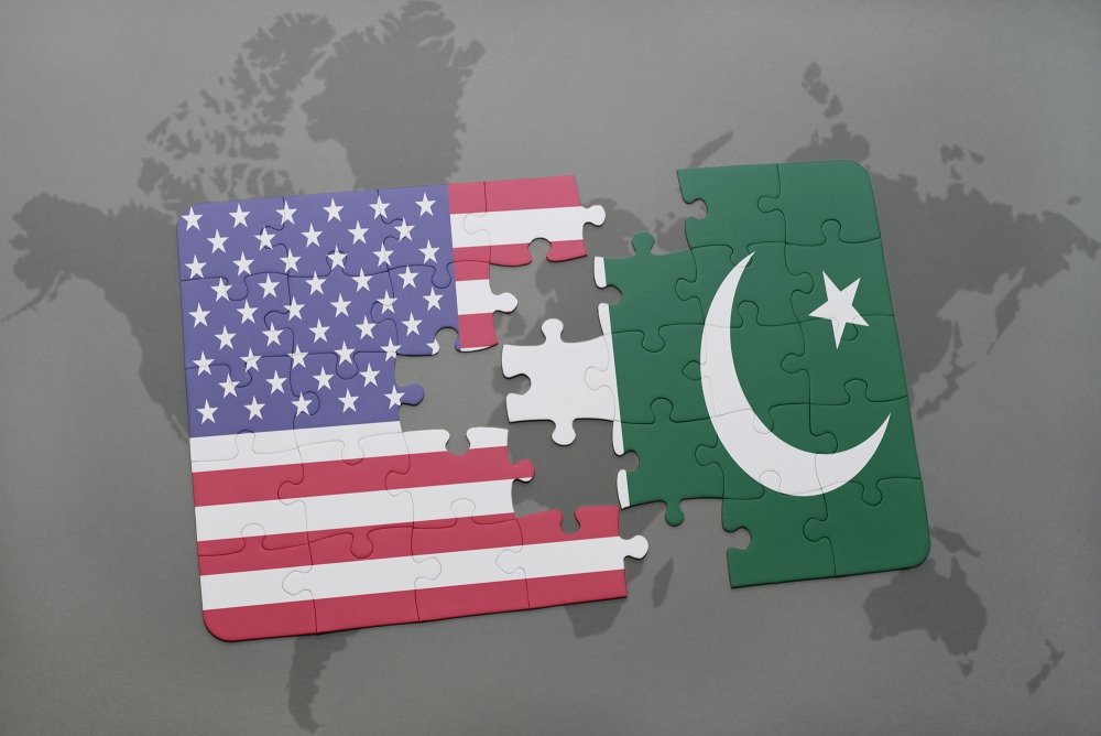 A puzzle that is split in the middle, one side showing the U.S. flag and the other the Pakistan flag