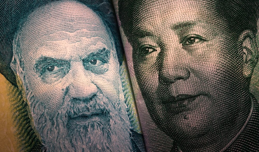 A very close shot showing details of the currency of Iran and China.