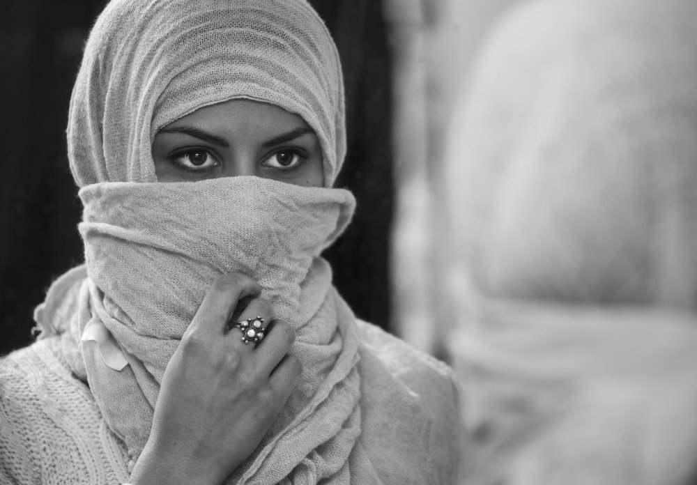 Cute hijab girl with camera and peace sign female photographer