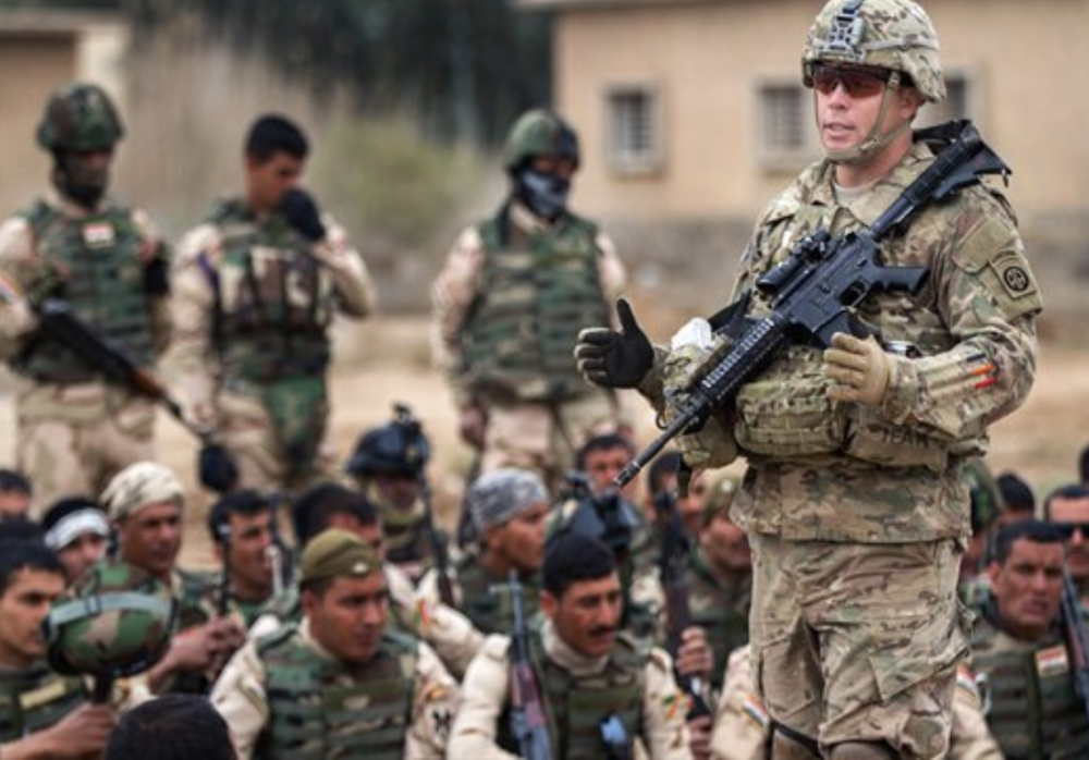 A U.S. soldier trains Iraqi soldiers at Camp Taji, Iraq on March 24, 2015.
