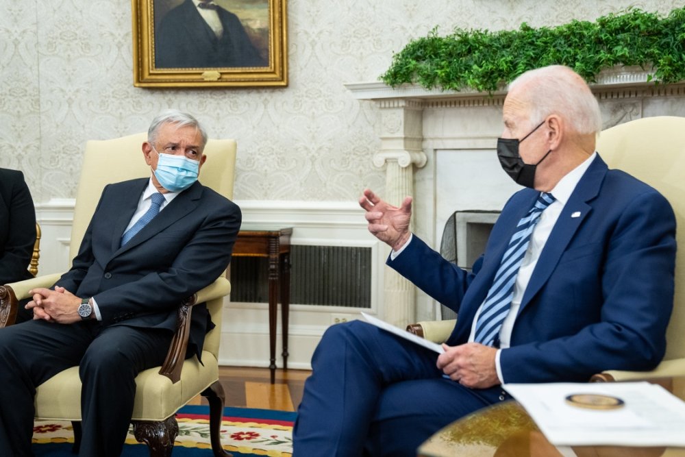 President Biden and President Lopez Obrador sit and talk. 
