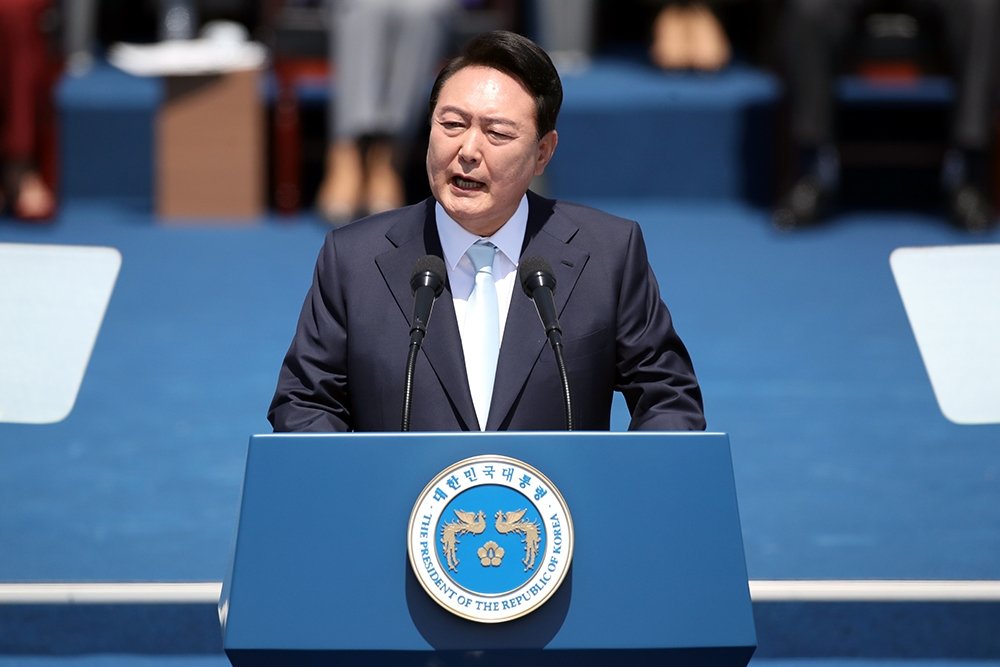 South Korean President Yoon standing at a podium giving a speech.