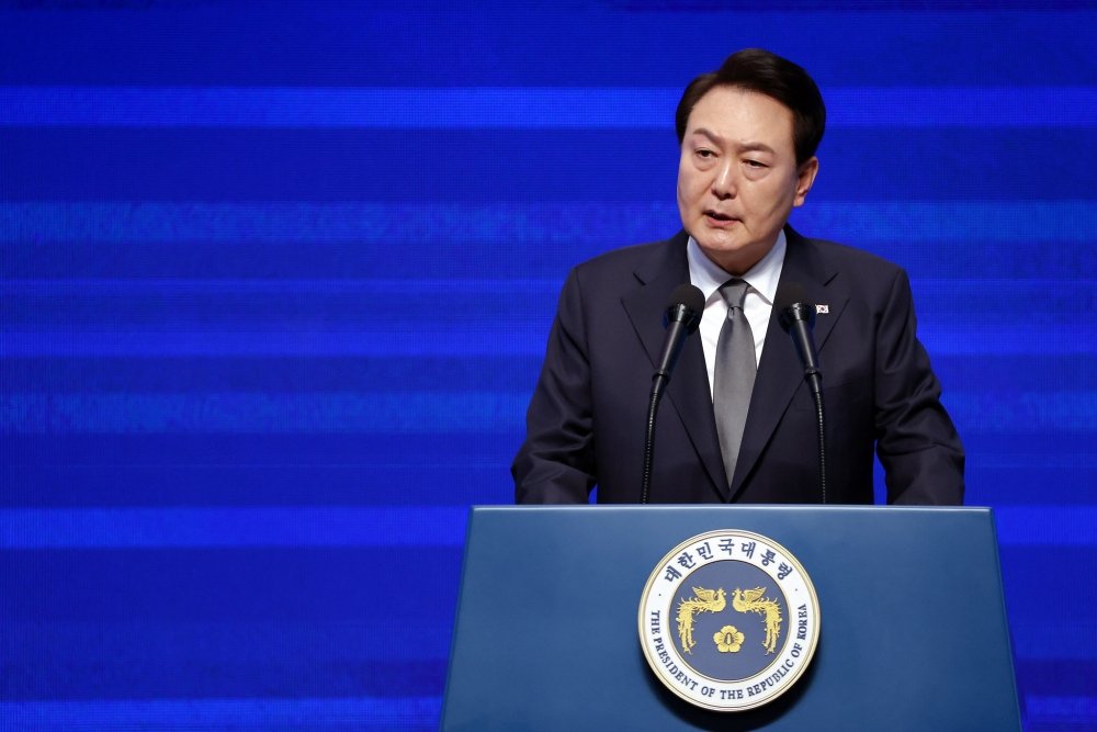 President Yoon stands at a podium while delivering a speech.