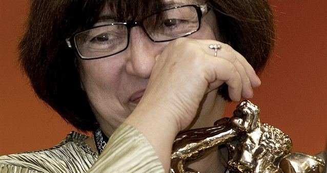 Close up of an older woman wiping away a tear