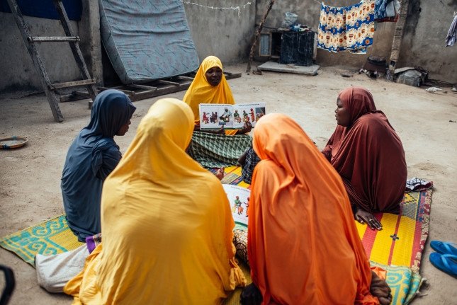 Hauwa Mustapha, 30, interacts with other women during mother-mother session within their community at Sulubri, Maiduguri, Borno, Nigeria.