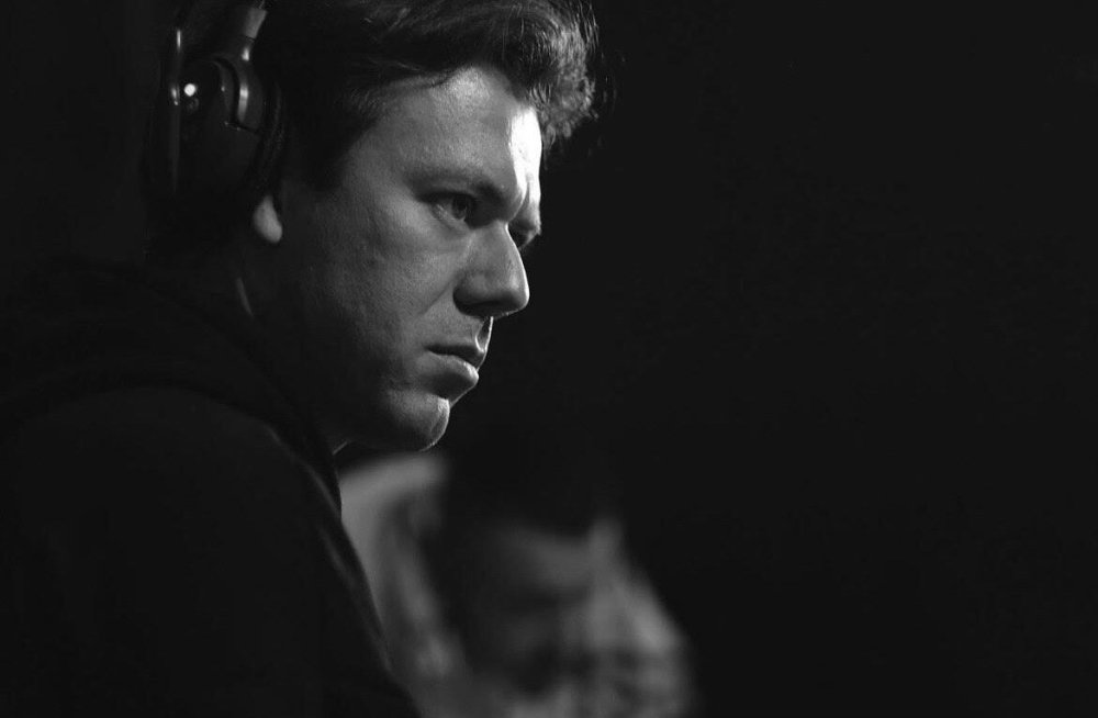 Black and white photo of man in profile wearing headphones