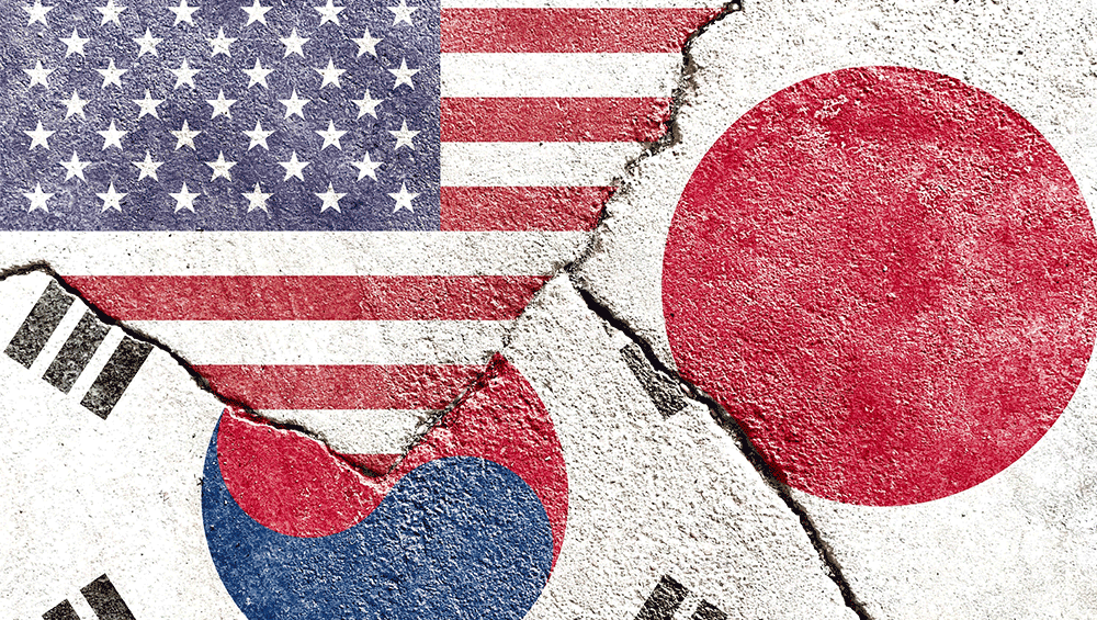 US, South Korea, and Japan Flags on concrete