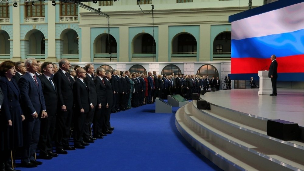 Putin on stage addressing the Federal Assembly of Russia