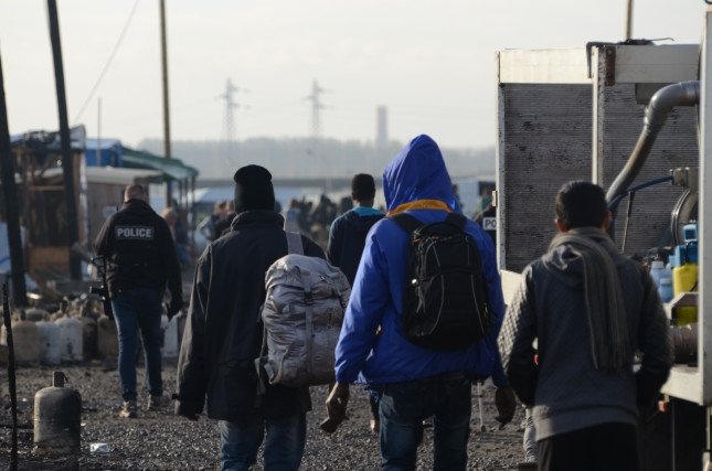 A group of migrants leave the Calais Jungle in Frane.