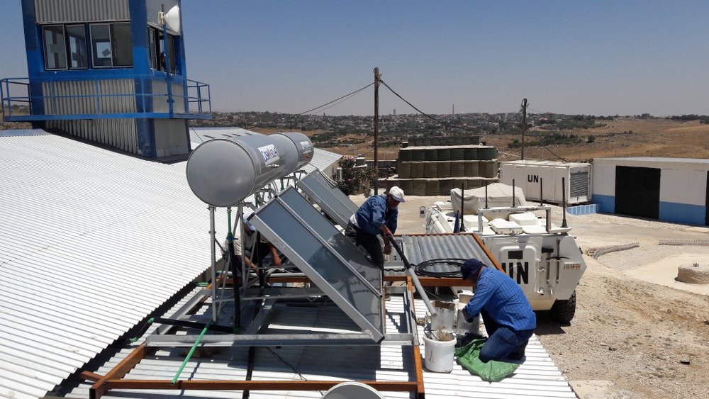 Workers installing solar power unit