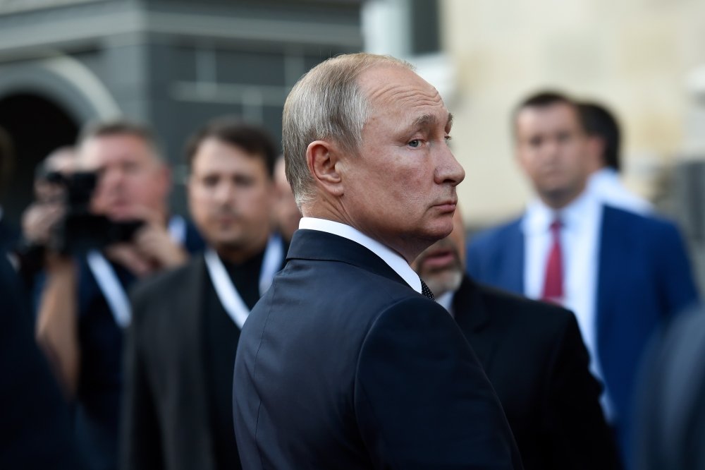 Vladimir Putin in profile looks over his shoulder