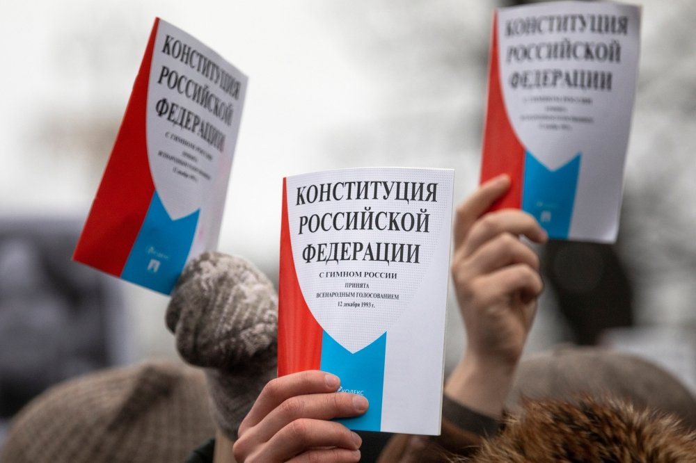 Opposition supporters hold a copy of Russia's constitution during a rally against constitutional reforms proposed by President Vladimir Putin in central Moscow.