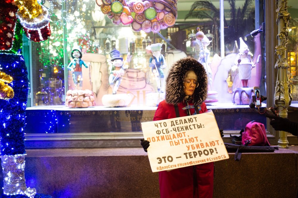 Protester with sign standing alone