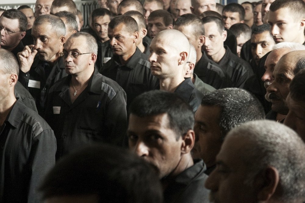 Large group of men in prisoner clothing 