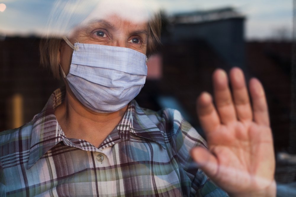 Masked Woman Against Window