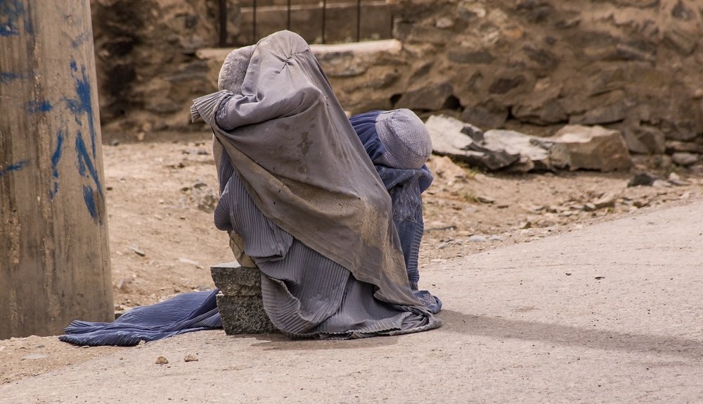 Afghan women in burqas on the side of the road