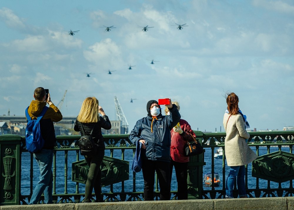 People in surgery masks outside during quarantine in Saint Petersburg, in celebration of Victory Day.