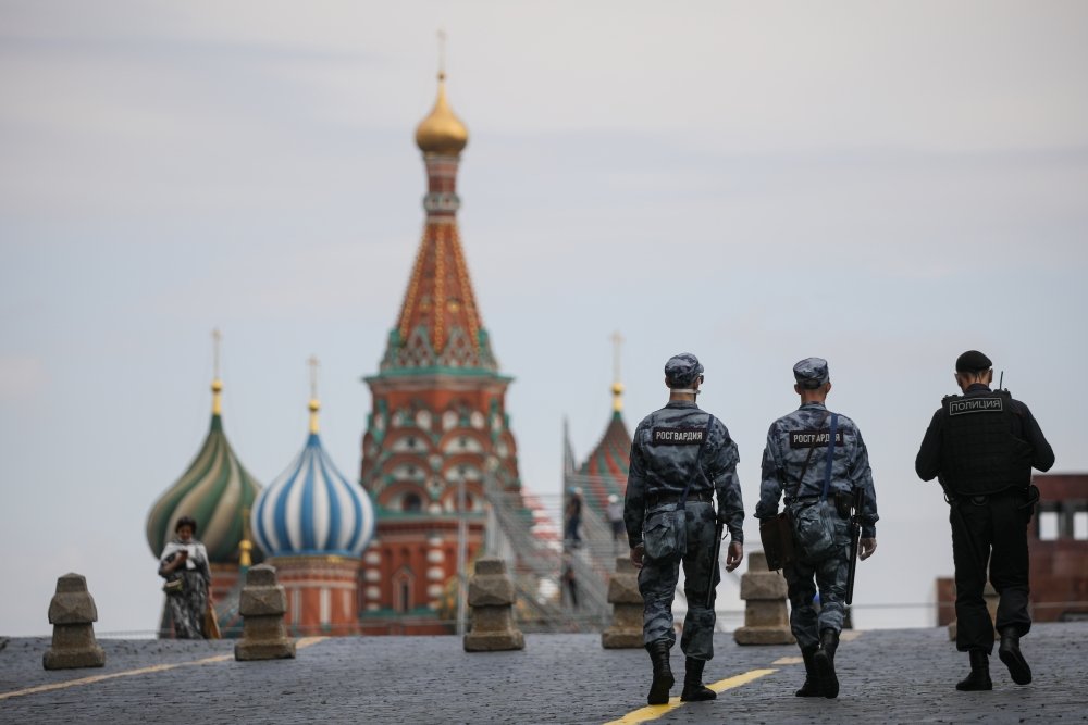 Russian police officers walk across Red Square.