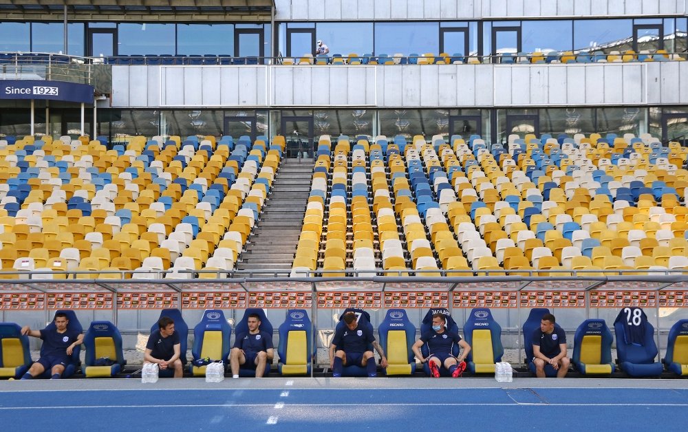 Desna Chernihiv players sit on a bench keeping a safe quarantine distance during the Ukrainian Premiere League game against Shakhtar at NSC Olympiyskyi stadium in Kyiv