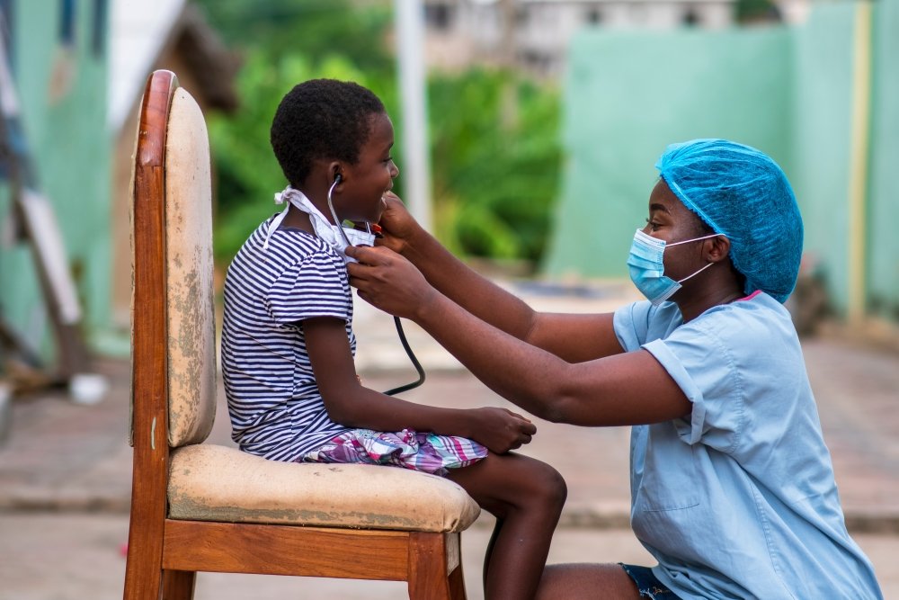 African doctor treating a child