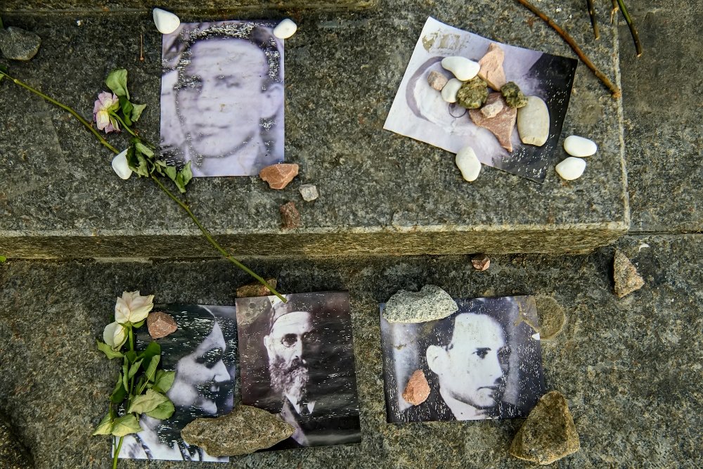 Portraits of killed Jews near Menorah monument in Memory of Jews Victims at the Babyn Yar National Historical Memorial. October 2020 Kyiv, Ukraine.