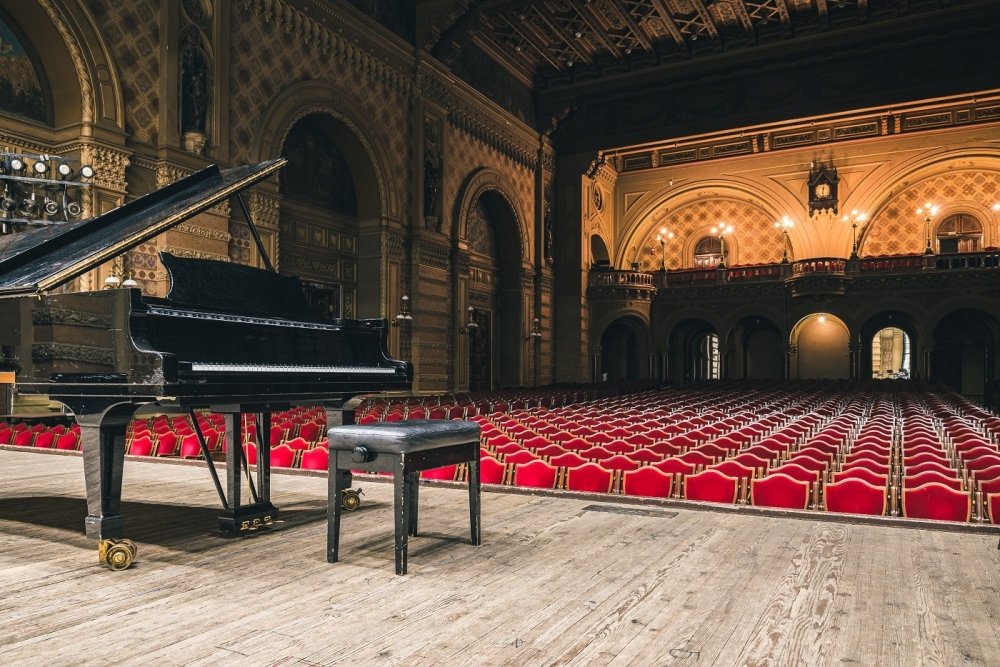 Image of piano on concert hall stage