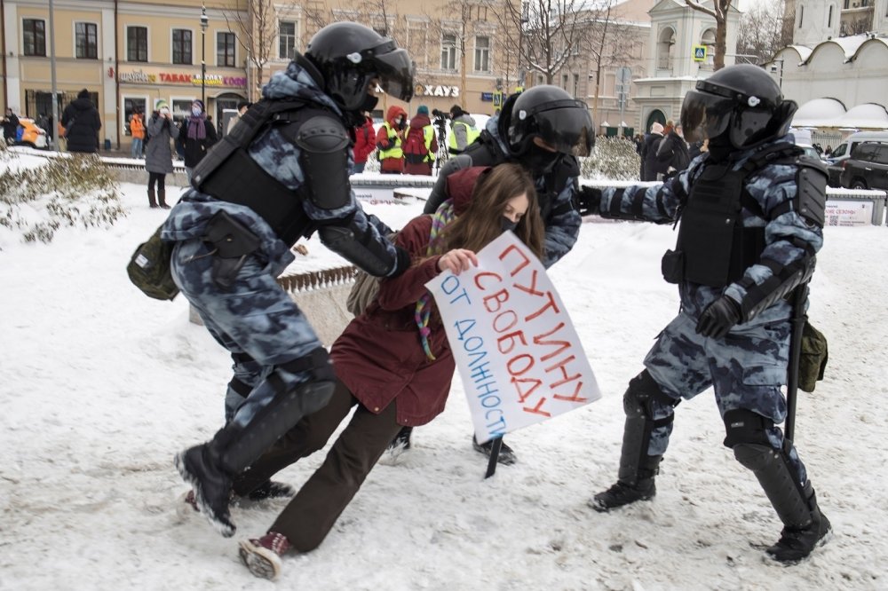 Police tackling a protester