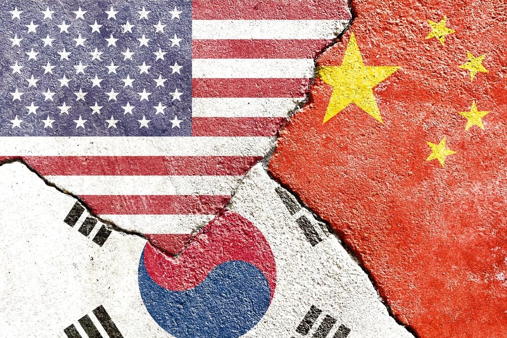 China, Korea, and US flags on concrete