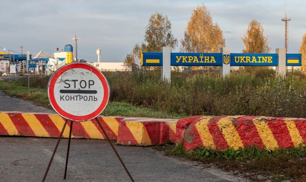Control sign and concrete blocks at the entrance to the Ukrainian checkpoint from Russia