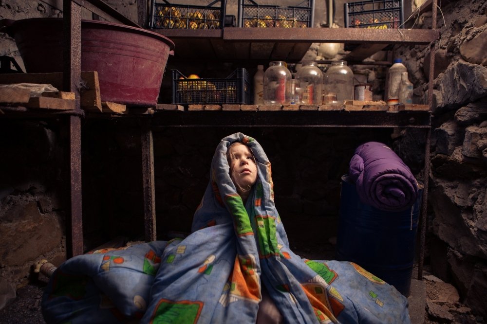 Ukrainian child takes shelter in her basement