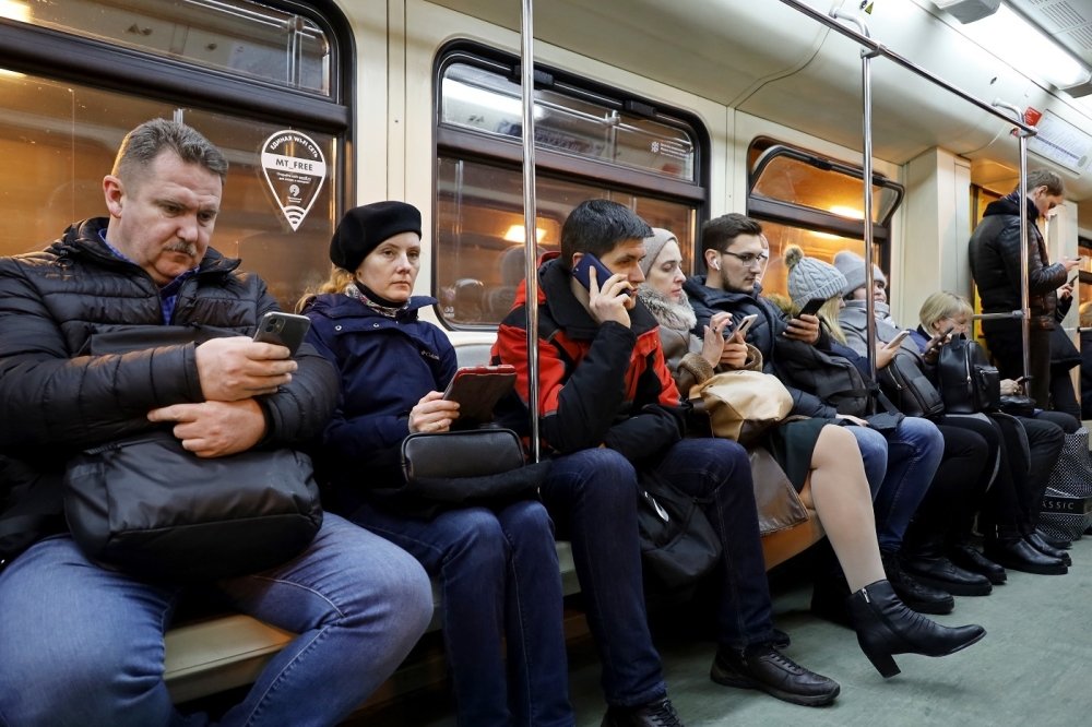 People sitting in a crowded train car